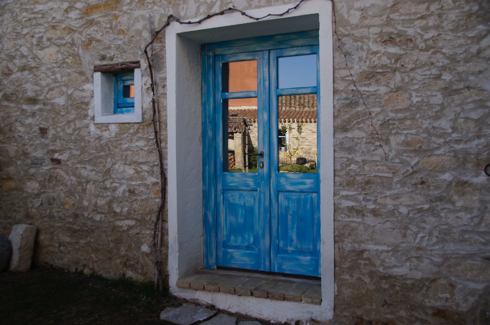 blue wooden door with glass panel
